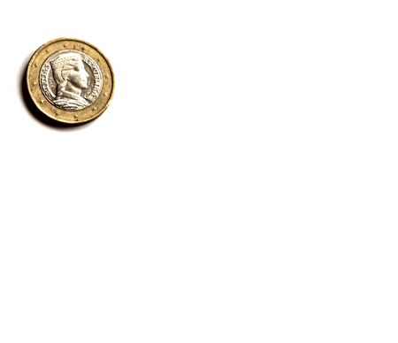 A metal coin of 1 euro lies in the corner of a white background. European money. Place for text.の写真素材