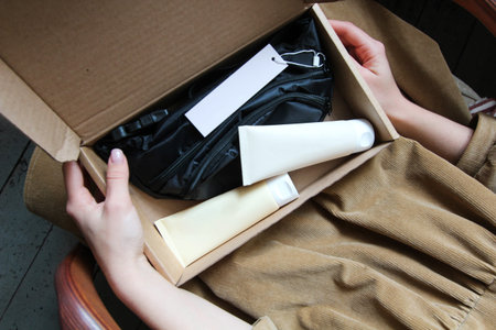 The girl in the hands holds a box. There lies cosmetics and a bag. Preset