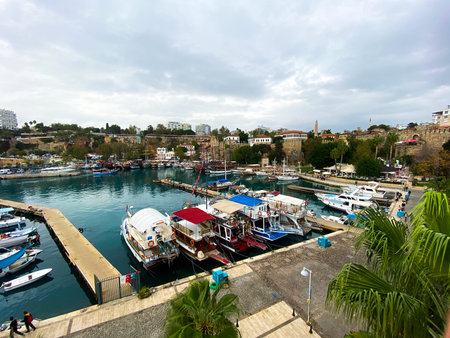 View of the fortress and boats in the port of the old city of Antalya. Tourist boats in the port. Tourism.のeditorial素材
