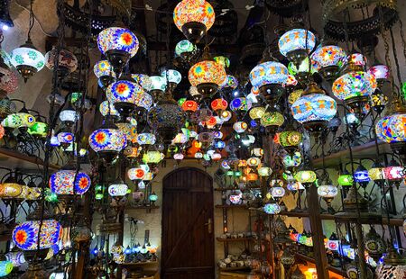 Colorful handmade Turkish lamps and lanterns hanging in souvenir shop for sale. Traditional turkish souvenirs.の写真素材