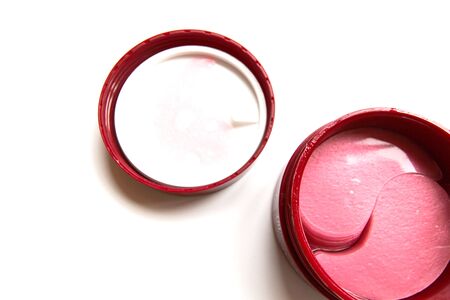 Cosmetic eye patches in a jar on a white background. Face skin care. Modern cosmetics. Top view. Copy space.の写真素材