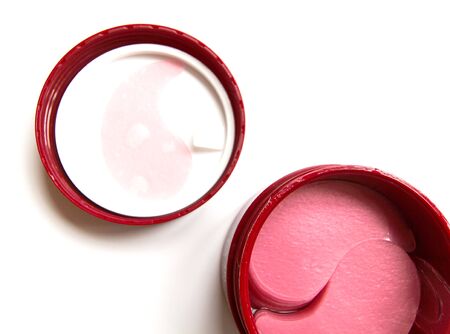 Cosmetic eye patches in a jar on a white background. Face skin care. Modern cosmetics. Top view. Place for text.の写真素材