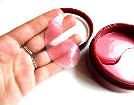 Cosmetic eye patches in a jar on a white background. Face skin care. Modern cosmetics. Top view. Place for text.の写真素材
