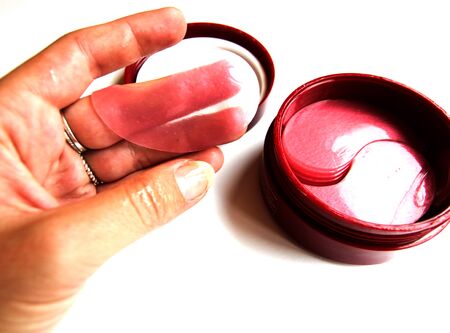 Cosmetic eye patches in a jar on a white background. Face skin care. Modern cosmetics. Top view. Place for text.の写真素材