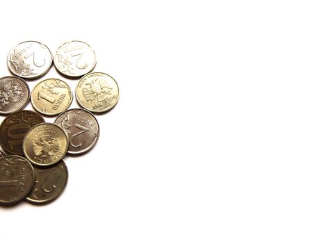 Several Russian coins lie on a white isolated background. Shiny Russian metal money.の写真素材