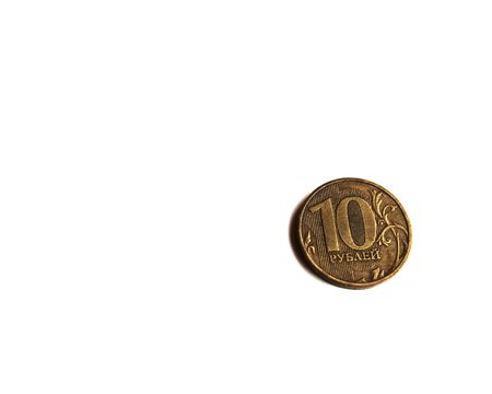 A metal coin of 10 Russian rubles lies in the corner of a white background. Russian money. Place for text.の写真素材