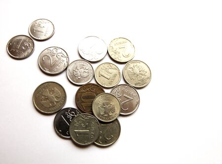 Several Russian coins lie on a white isolated background. Shiny Russian metal money.の写真素材