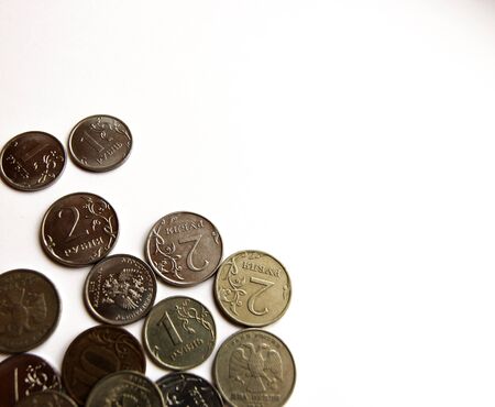 Several Russian coins lie on a white isolated background. Shiny Russian metal money.の写真素材