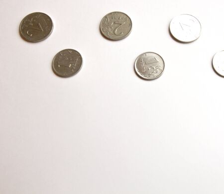 Several Russian coins lie on a white isolated background at the top. Place for text.の写真素材
