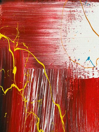 Red, yellow and white strokes of paint on the fabric. Abstract textured background.の写真素材