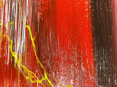 Red, yellow and white strokes of paint on the fabric. Abstract textured background.の写真素材