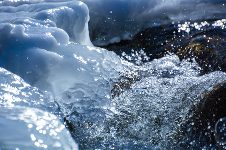Splashing water among the ice on the riverの写真素材