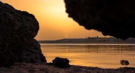 Sunrise on the coast of the mountain lake Issyk-Kul Kyrgyzstan.の写真素材