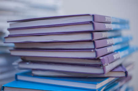 a stack of books lying on top of each otherの写真素材