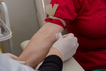 The nurse wipes the injection site with alcoholの写真素材