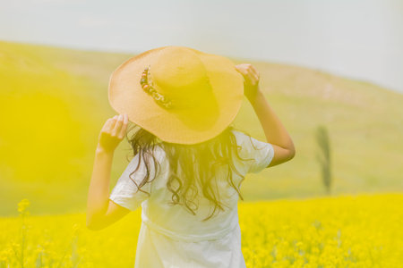 Girl's back on the field in flowers