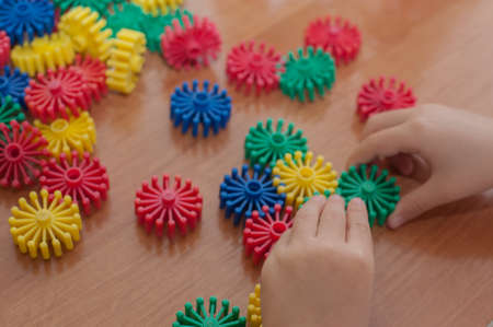 the child collects the constructor at the tableの写真素材