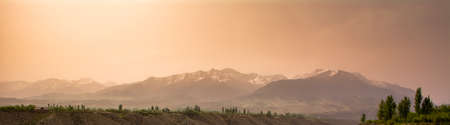 Panorama of a mountain range at dawn Kyrgyzstan,の写真素材