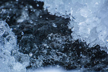 Splashing water among the ice on the riverの写真素材