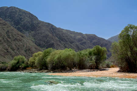 The confluence of two mountain rivers with water of different colors.の写真素材