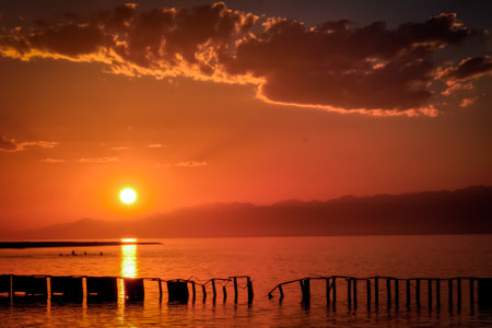 Sunset on the alpine lake Issyk-Kul Kyrgyzstan, background focusの写真素材