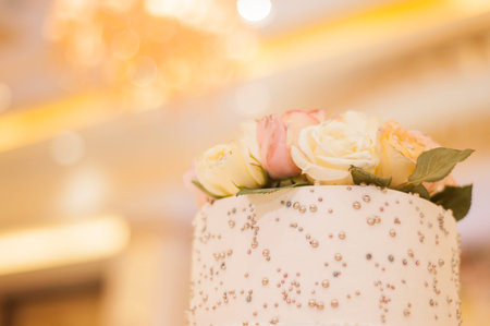wedding cake decorated with chewy roses.の写真素材