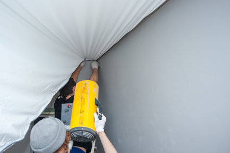 The process of stretching and installing suspended ceilingsの写真素材