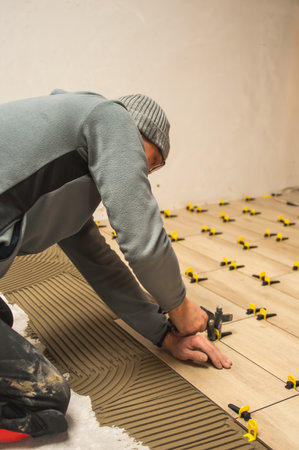 The process of laying floor tiles on the SVP Base, Tile Leveling Systemの写真素材