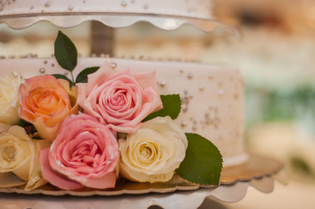 wedding cake decorated with chewy roses.の写真素材