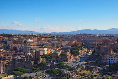 ROME, ITALY - JANUARY 6, 2017: View to rooftops of Rome skyline from the Monument of Vittorio Emanuele at Piazza Venezia. Rome Forum with ruins of historical buildings. Colosseum in the background. Winter morning view.のeditorial素材
