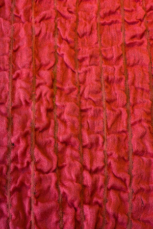 Red background with wavy fabric texture.