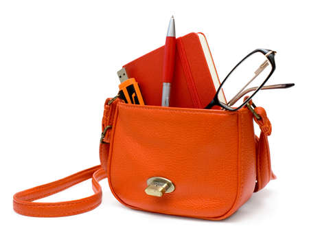Small bag with office supplies  pendrive, glasses, notebook, pen   Isolated on white の写真素材