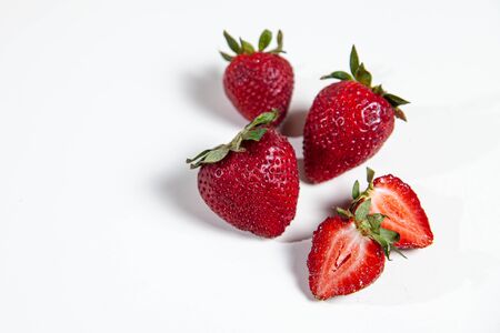 red strawberries on a white tableの写真素材