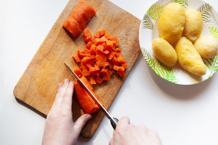cut boiled carrots, boiled potatoes in a plateの写真素材
