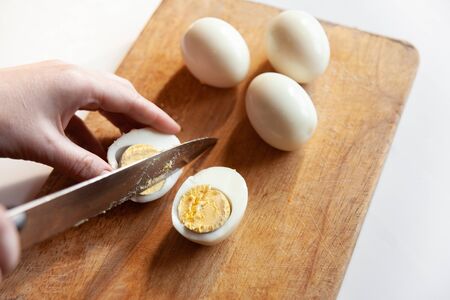 cut the egg on a cutting Boardの写真素材