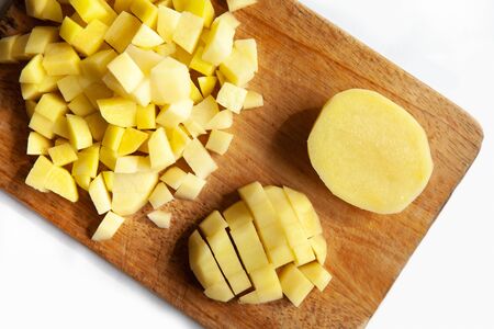 diced potatoes on a cutting Boardの写真素材