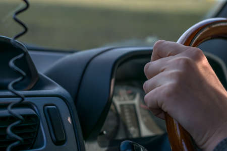 view of the hand of the people, the driver, holding the wheel of the car, closeupの写真素材
