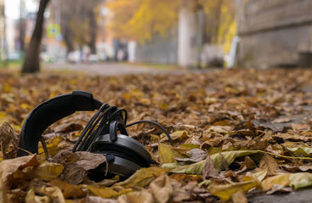 audio old headphones lying in the streetの写真素材