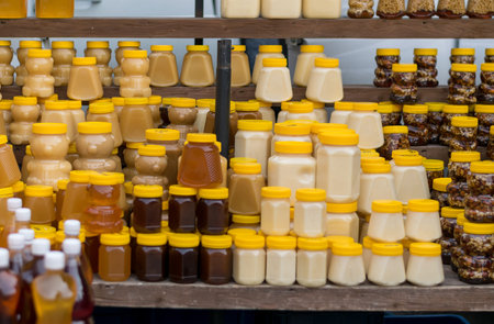 honey stands on a wooden counterの写真素材