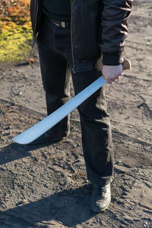 machete in the hand of a manの写真素材