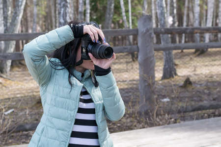 Girl photographer taking picturesの写真素材