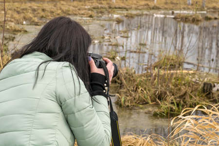 A girl taking pictures of natureの写真素材