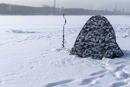 Tourist tent and drill for winter fishingの写真素材