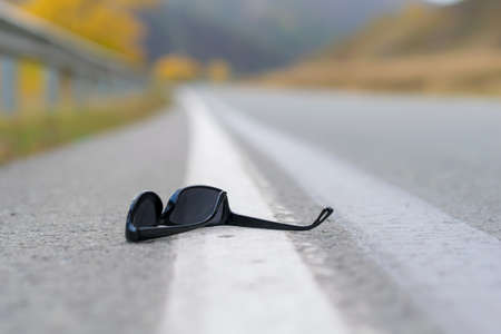 close up, lost sunglasses lie on the roadの写真素材