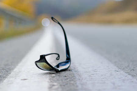 close up, lost sunglasses lie on the roadの写真素材