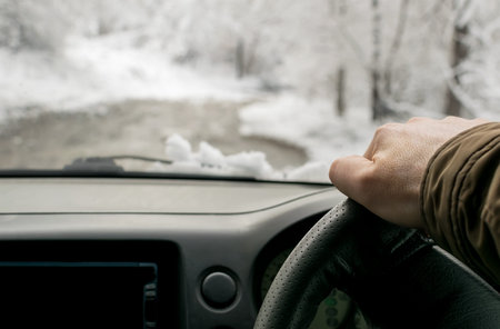 Man's hand on the steering wheel