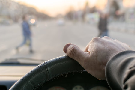 man's hand on the steering wheel