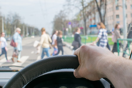 man's hand on the steering wheel