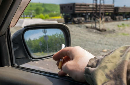 hand men with a cigarette in the carの写真素材