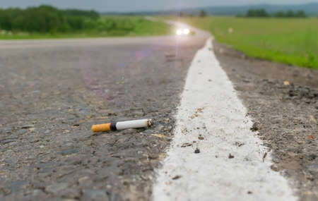 cigarette lying on the roadの写真素材